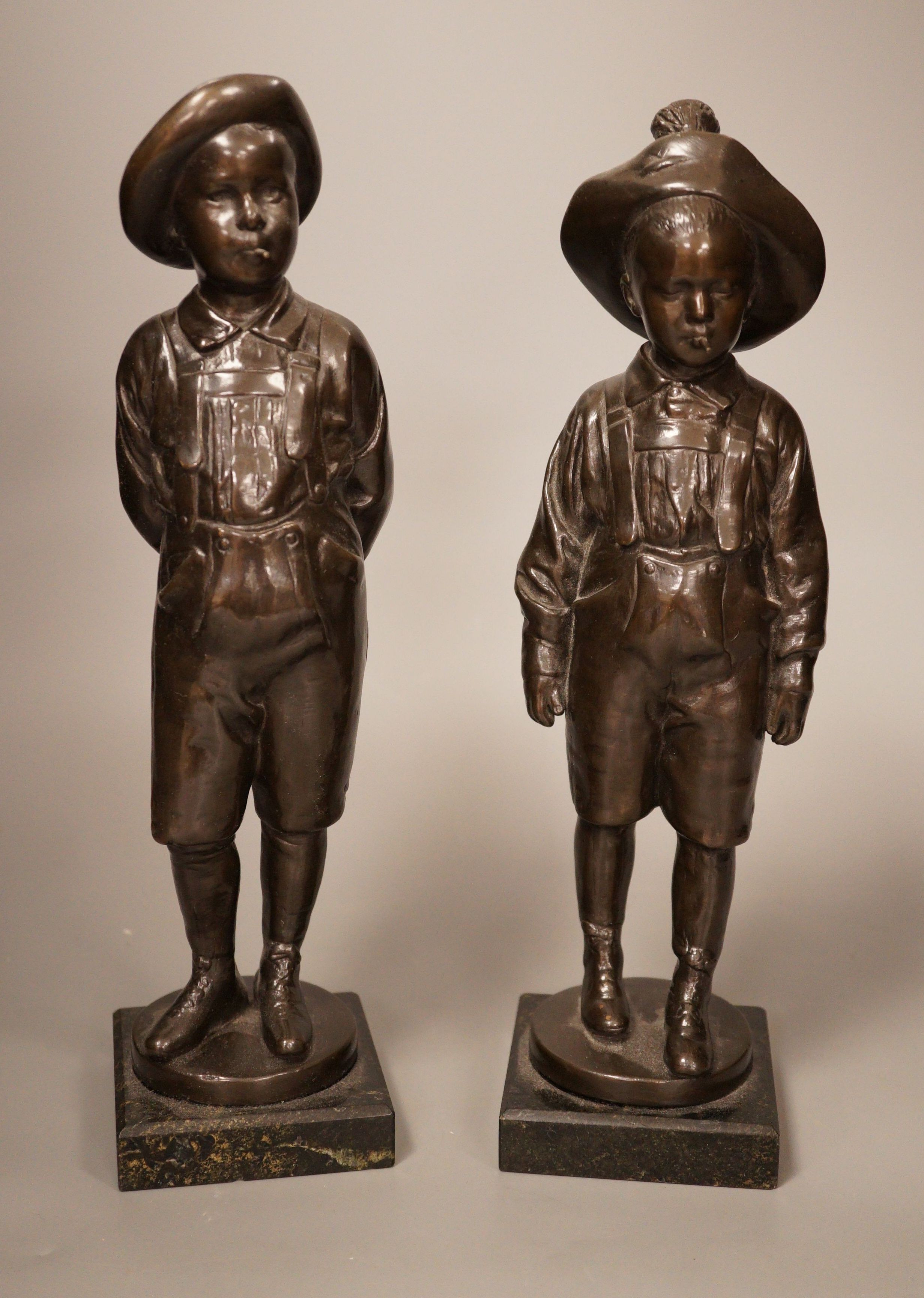 A pair of 20th century patinated metal figures of ruffians, marble bases, tallest 30cm